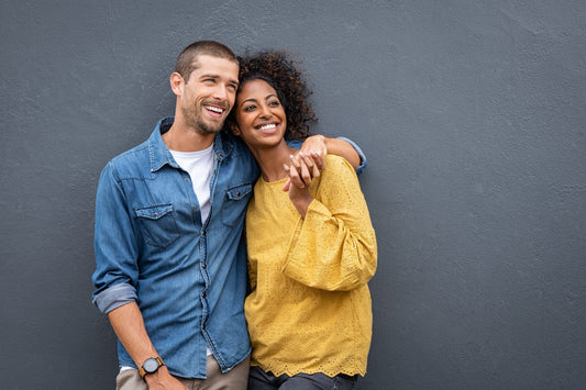 A couple smiling and embracing warmly
